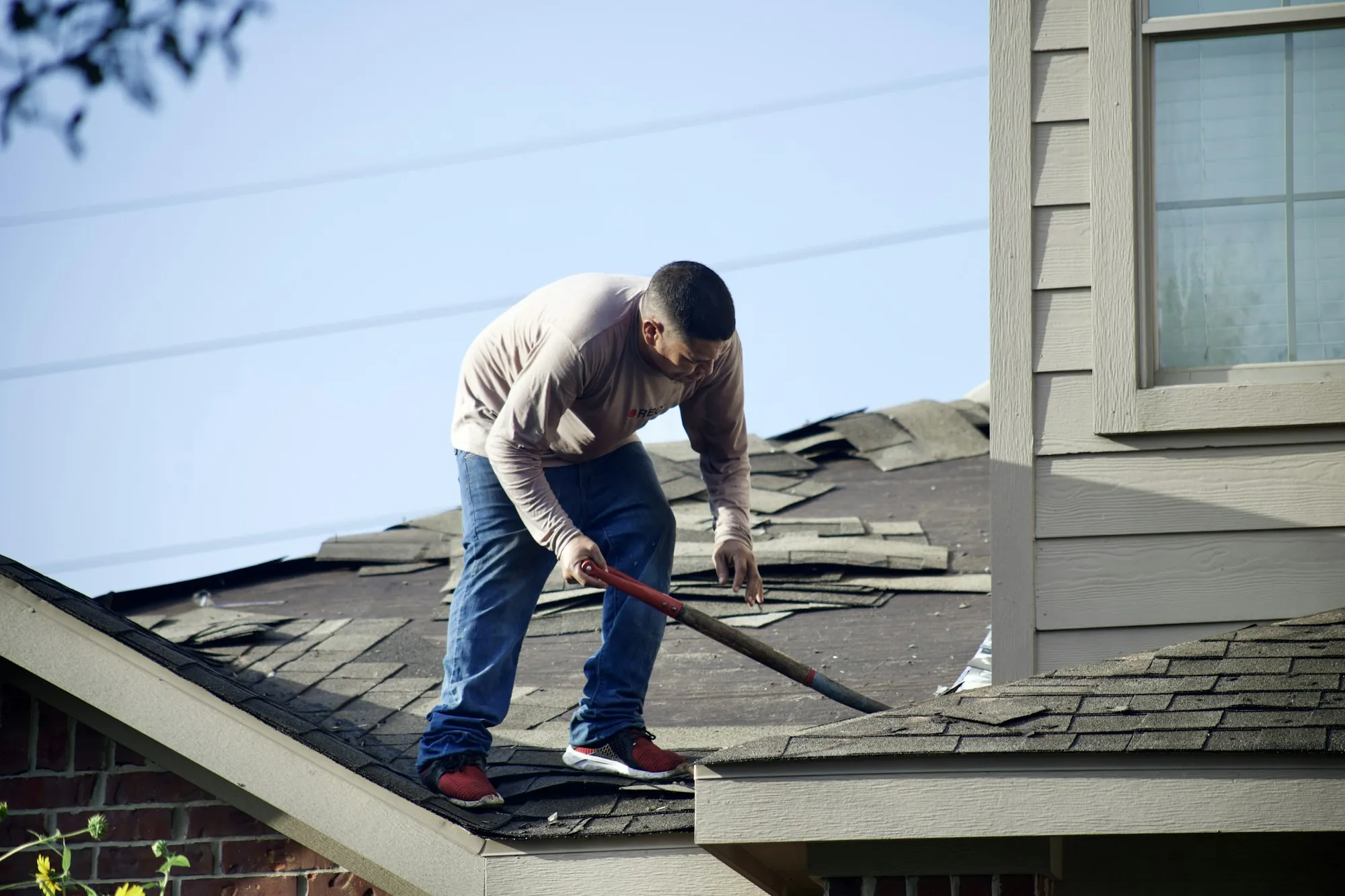 Roof shingles and a ridge against the sky