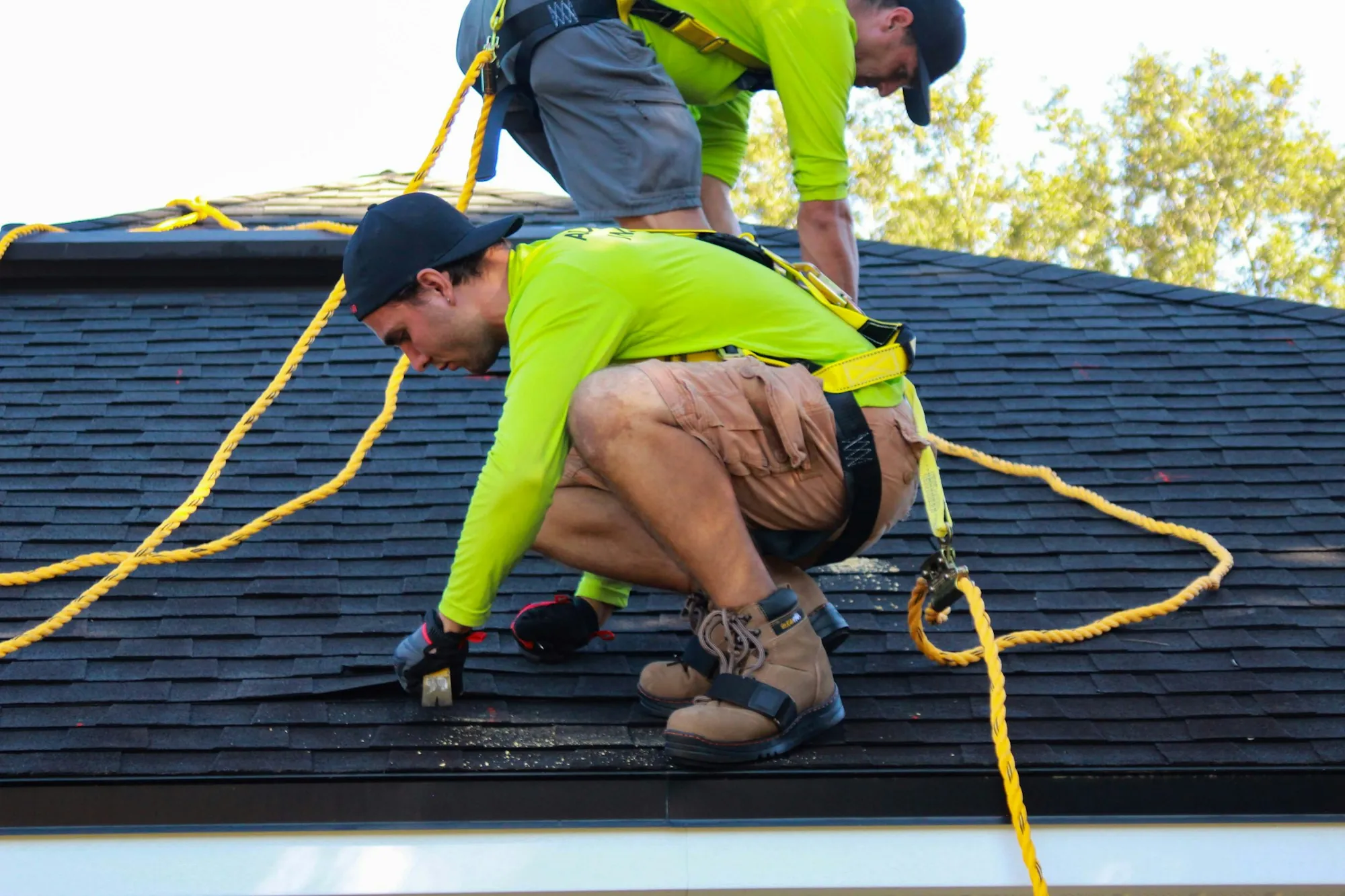 A gutter and downspout along a roof eave