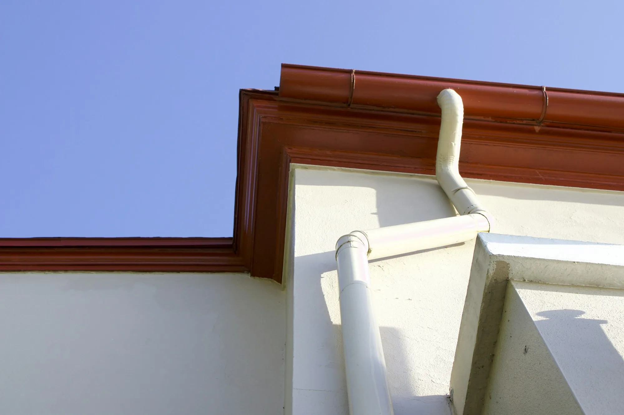 A roof penetration and surrounding shingles